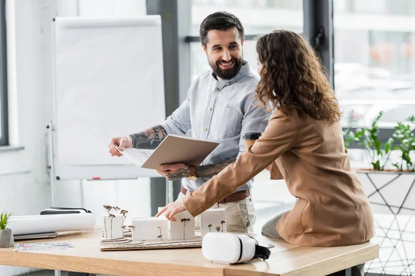 Virtual reality architects talking and pointing with finger at model of house — Stock Photo