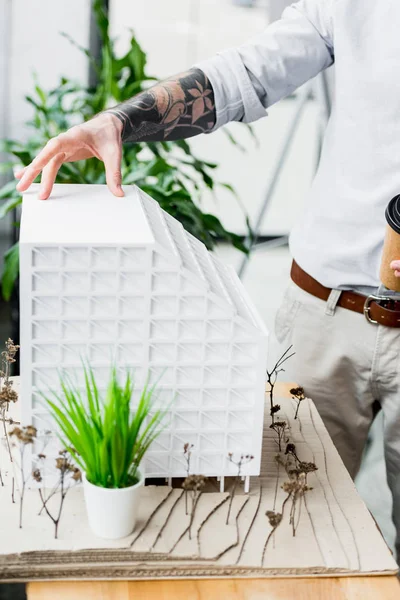 Cropped view of virtual reality architect touching model of house — Stock Photo