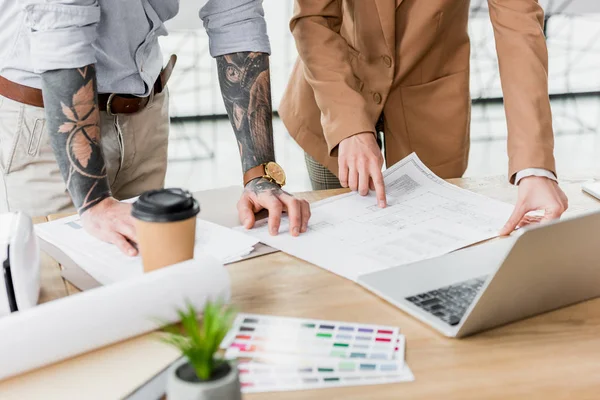 Cropped view of virtual reality architects looking and pointing with finger at project — Stock Photo