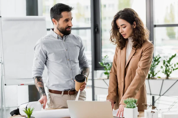 Virtual reality architects standing near table and talking in office — Stock Photo