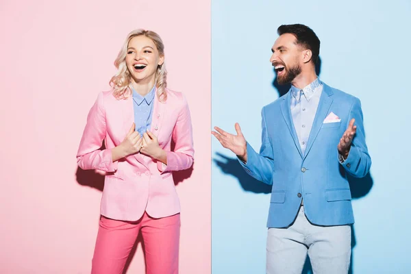 Attractive woman and handsome man smiling on pink and blue background — Stock Photo