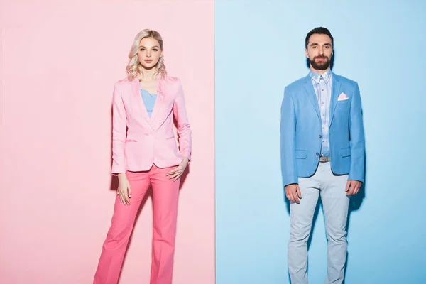 Attrayant femme et bel homme regardant la caméra sur fond rose et bleu — Photo de stock