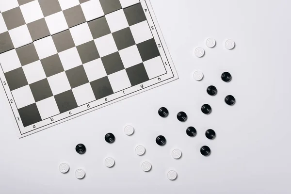 Top view of chessboard and checkers isolated on white — Stock Photo