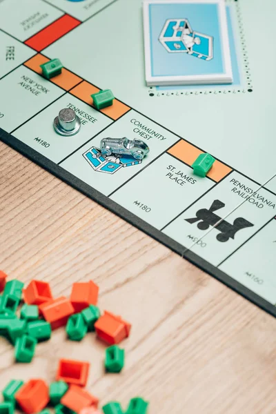 KYIV, UKRAINE - NOVEMBER 15, 2019: Selective focus of monopoly game with cards and figures on table — Stock Photo