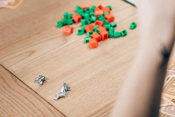 KYIV, UKRAINE - NOVEMBER 15, 2019: Selective focus on woman by monopoly game on wooden table — Stock Photo