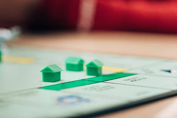 KYIV, UKRAINE - NOVEMBER 15, 2019: Selective focus of playing figures on monopoly board game — Stock Photo