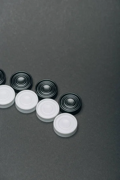 Rows of black and white checkers isolated on grey — Stock Photo