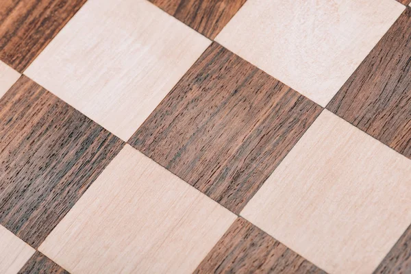 Close up view of surface of wooden checkerboard — Stock Photo