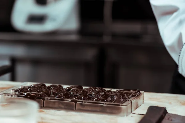 Sweet and dark melted chocolate in ice tray — Stock Photo
