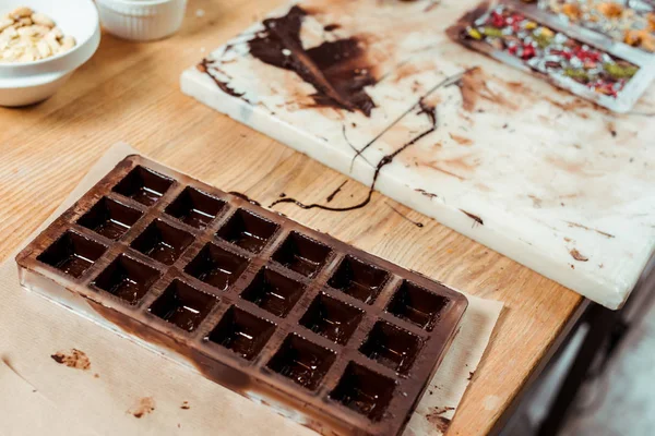 Selective focus of chocolate molds with melted chocolate — Stock Photo