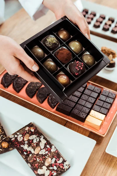 Vista recortada de la caja de espera chocolatero con sabrosas y frescas bolas de chocolate hechas - foto de stock