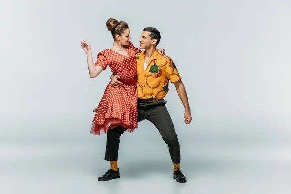Junge Tänzerin mit Partnerin beim Boogie-Woogie-Tanz auf grauem Hintergrund — Stockfoto