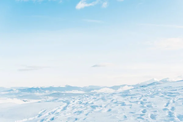 Scenic view of snowy mountain with traces and pure blue sky — Stock Photo