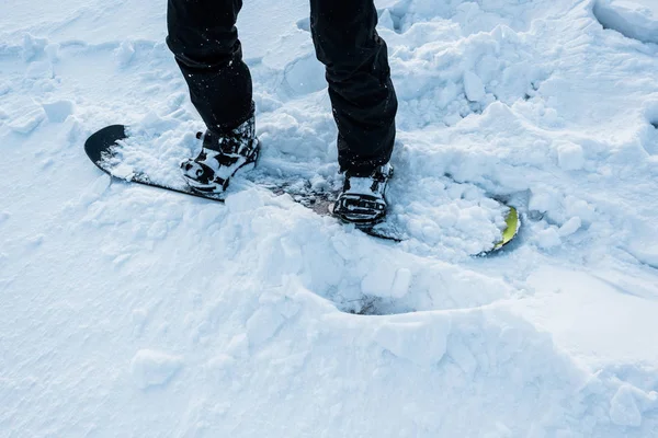 Cropped view of snowboarder riding on white snow in winter — Stock Photo