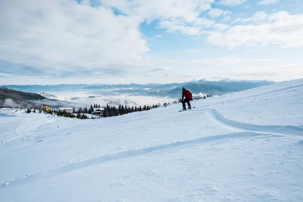 Snowboarder riding on slope with white snow in wintertime — Stock Photo