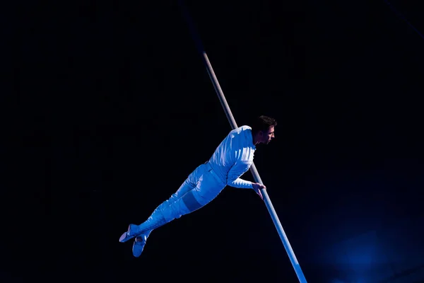 Handsome acrobat balancing in arena of circus — Stock Photo