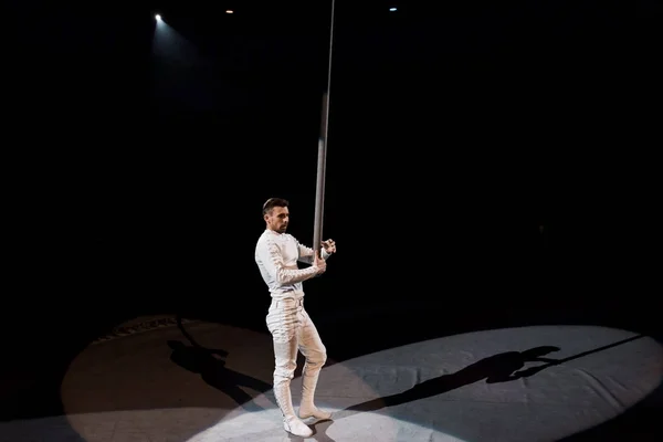 Handsome acrobat standing near metallic pole in circus — Stock Photo