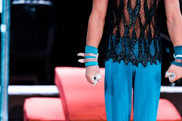 Cropped view of gymnast standing with clenched fists in circus — Stock Photo