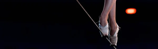 Panoramic shot of aerial acrobat walking on tip toe on rope — Stock Photo