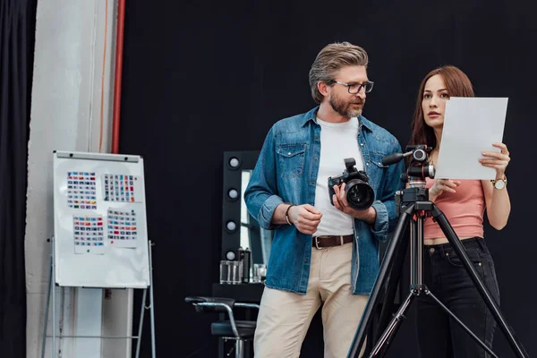 Attractive art director standing near bearded photographer — Stock Photo