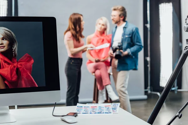 Selective focus of computer monitor with photo of model near computer mouse and collage — Stock Photo