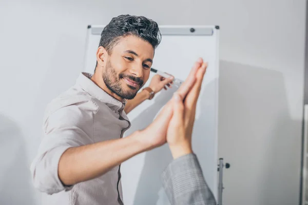 Selective focus of happy mixed race scrum master giving high five to businesswoman — Stock Photo