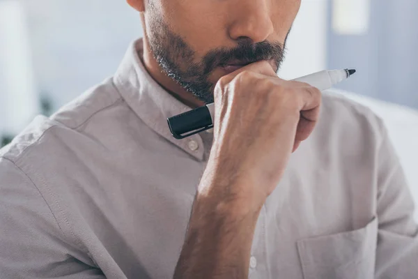 Cropped view of bearded mixed race man holding marker pen — Stock Photo