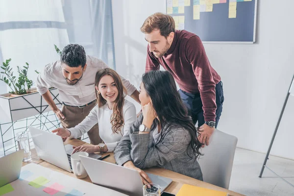 Happy multicultural businessmen and businesswomen in office — Stock Photo