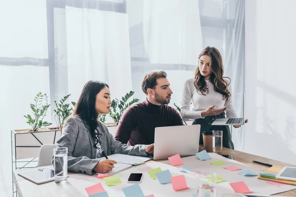 Multicultural coworkers working with gadgets in office — Stock Photo