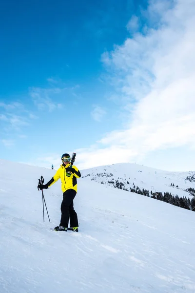 Skier with ski sticks standing on white snow outside — Stock Photo