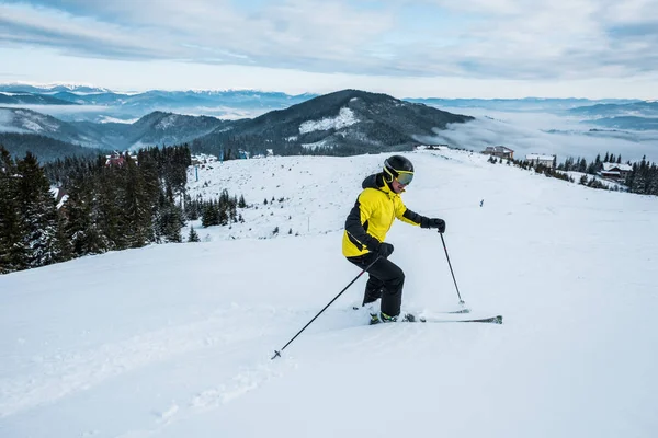 Sportsman holding ski sticks while skiing in wintertime — Stock Photo