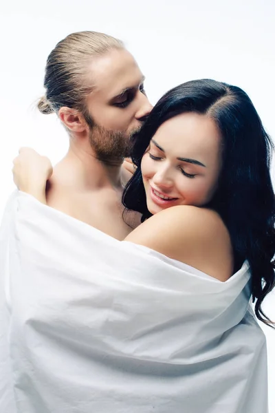 Sexy casal positivo abraçando em folhas brancas, isolado no branco — Fotografia de Stock