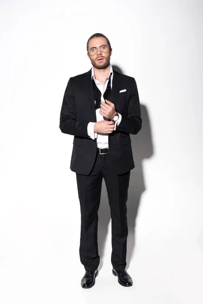 Elegant handsome man in black suit on white — Stock Photo