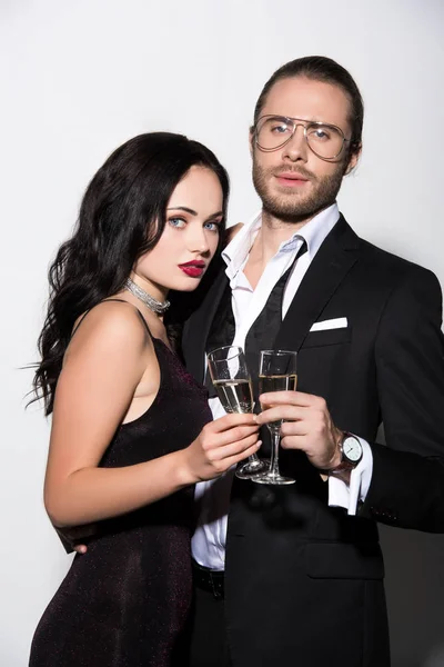 Beautiful couple clinking with champagne glasses for valentines day on white — Stock Photo
