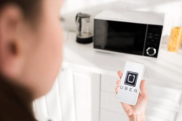 KYIV, UKRAINE - OCTOBER 9, 2019: cropped view of woman holding smartphone with uber app — Stock Photo