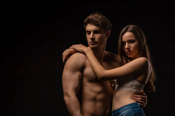 Sexy young couple hugging isolated on black — Stock Photo