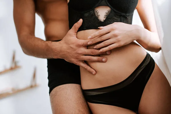 Cropped view of shirtless man hugging sexy girlfriend — Stock Photo