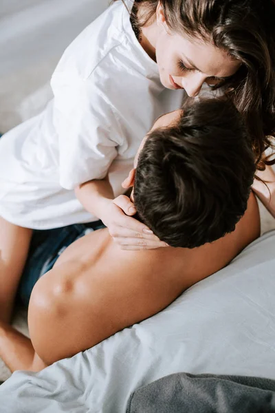 Selective focus of young happy woman hugging man in bedroom — Stock Photo