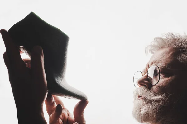 Senior cobbler in glasses holding shoe last isolated on white — Stock Photo