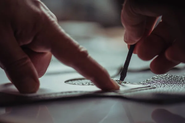 Cropped view of shoemaker marking leather with special pen near template — Stock Photo