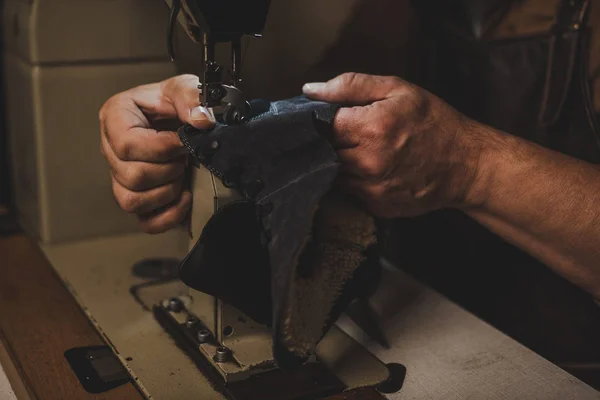 Cropped view of cobbler sewing part of leather shoe on sewing machine — Stock Photo