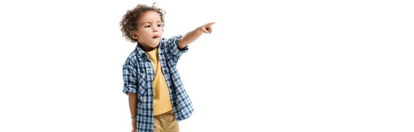 Panoramic shot of little african american boy pointing isolated on white — Stock Photo