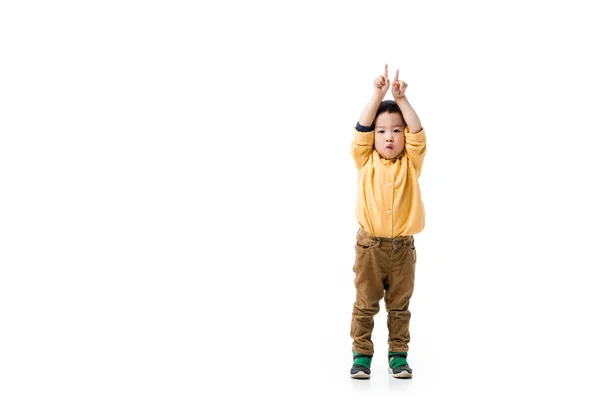 Shocked asian boy pointing up isolated on white — Stock Photo