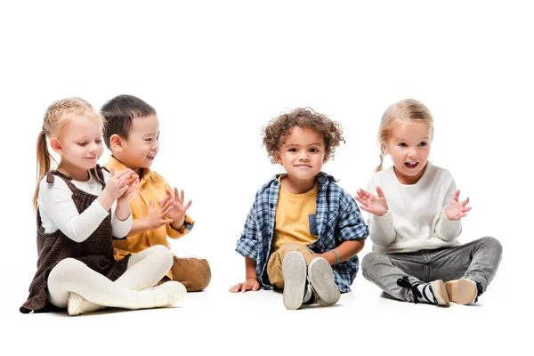 Happy adorable multicultural kids playing on white — Stock Photo