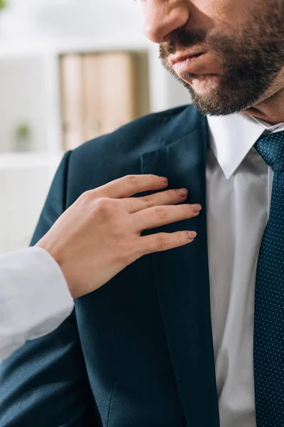 Cropped view of secretary touching businessman in office — Stock Photo