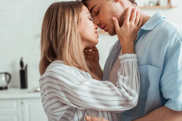 Attractive woman with closed eyes touching boyfriend — Stock Photo