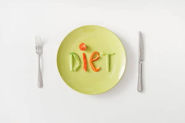 Top view of diet lettering on plate with cutlery on white background — Stock Photo