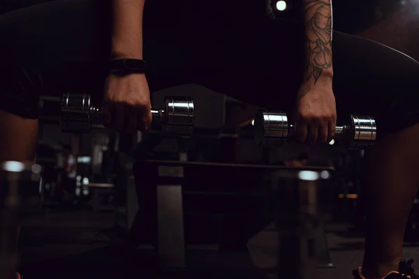 Cropped view of african american young adult squating with dumbbells — Stock Photo