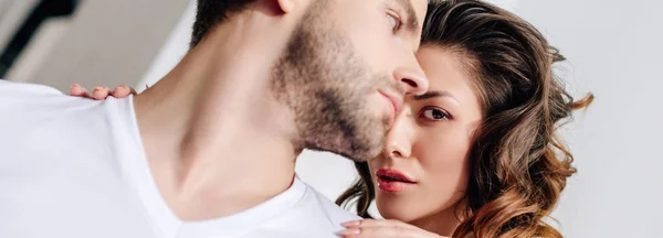 Panoramic shot of woman hugging handsome man in t-shirt — Stock Photo