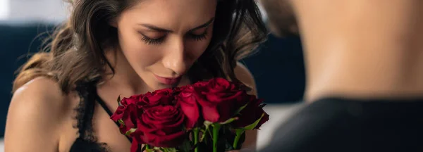 Panoramic shot of attractive girlfriend smelling roses in 14 february — Stock Photo